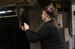 Anna Krogshave Dahlgren adjusts processing machine